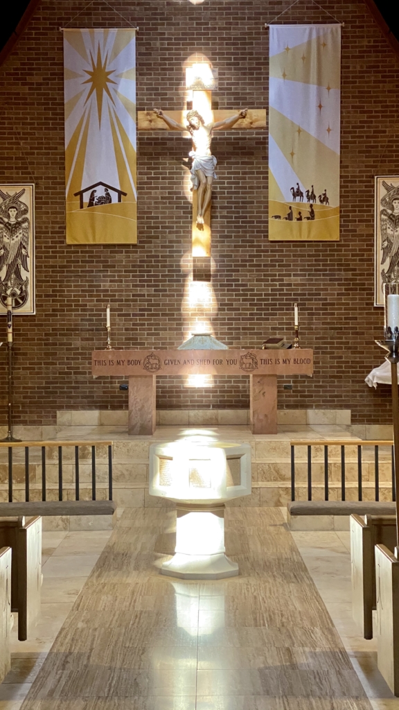 The baptismal font, altar and crucifix at Trinity Lutheran Church, Denver, CO